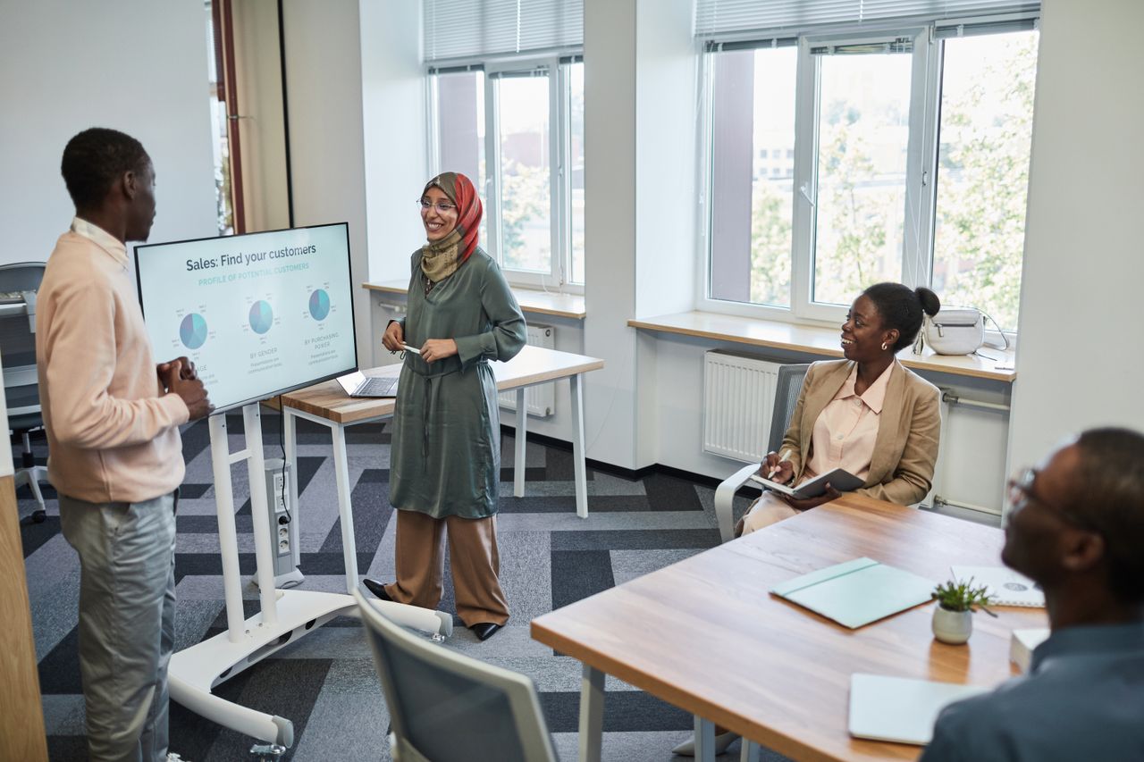 services-03 Multicultural team having a business presentation in a modern office setting.
